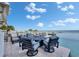 Waterfront outdoor patio area, showcasing comfortable seating and an infinity-edge pool, perfect for enjoying ocean views at 6418 Bright Bay Ct, Apollo Beach, FL 33572