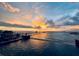 A stunning waterfront home view with a dock and captivating sunset views from the pool at 6418 Bright Bay Ct, Apollo Beach, FL 33572