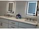 Modern bathroom featuring dual sinks, stylish fixtures, and lighted mirrors above the vanities at 644 3Rd S Ave # 402, St Petersburg, FL 33701