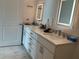 Bathroom featuring double sinks with illuminated mirrors and modern fixtures at 644 3Rd S Ave # 402, St Petersburg, FL 33701