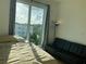 Bedroom featuring modern futon and large window offering views, paired with hardwood floors at 644 3Rd S Ave # 402, St Petersburg, FL 33701