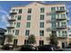 Exterior of building featuring multiple balconies and lush landscaping at 644 3Rd S Ave # 402, St Petersburg, FL 33701
