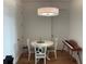 Dining room with a round table, white chairs, and a modern light fixture at 644 3Rd S Ave # 402, St Petersburg, FL 33701