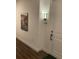Hallway entrance to unit 402 with artwork and modern sconce lighting at 644 3Rd S Ave # 402, St Petersburg, FL 33701