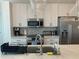 Modern kitchen boasting quartz countertops, stainless steel appliances, and ample cabinet space at 644 3Rd S Ave # 402, St Petersburg, FL 33701