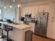 Modern kitchen with stainless steel appliances, quartz countertops, pendant lighting and hardwood floors at 644 3Rd S Ave # 402, St Petersburg, FL 33701