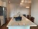 Kitchen island features a large countertop with a sink, stainless steel refrigerator and hardwood floors at 644 3Rd S Ave # 402, St Petersburg, FL 33701