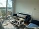 Inviting living room with blue sofa, stylish coffee table, and a bright balcony view at 644 3Rd S Ave # 402, St Petersburg, FL 33701