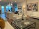 Open-concept living room with white sofas, island seating, and modern decor with hardwood floors at 644 3Rd S Ave # 402, St Petersburg, FL 33701