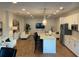 Bright open living room featuring white sofas, island with chairs, stainless appliances and modern finishes at 644 3Rd S Ave # 402, St Petersburg, FL 33701