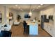 Bright open living room featuring white sofas, island with chairs, stainless appliances and modern finishes at 644 3Rd S Ave # 402, St Petersburg, FL 33701