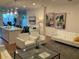 Open-concept living space featuring living room, kitchen island, white couches, and natural light at 644 3Rd S Ave # 402, St Petersburg, FL 33701