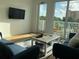 Sunlit living room with modern furniture, a large window, and an outdoor balcony at 644 3Rd S Ave # 402, St Petersburg, FL 33701