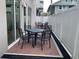 Outdoor patio area with brick flooring, seating, and a white privacy fence at 644 3Rd S Ave # 402, St Petersburg, FL 33701