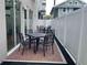 Outdoor patio area with brick flooring, seating, and a white privacy fence at 644 3Rd S Ave # 402, St Petersburg, FL 33701