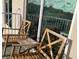 Inviting outdoor patio with comfortable wooden chairs, perfect for relaxation and enjoying the view at 644 3Rd S Ave # 402, St Petersburg, FL 33701