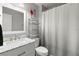 Bathroom featuring a large mirror, neutral walls, and a vanity with ample counter space at 6681 121St Ave # I, Largo, FL 33773