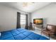 Cozy bedroom featuring a comfortable bed, chair, and a TV on a side table at 6681 121St Ave # I, Largo, FL 33773