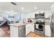 Bright kitchen with stainless steel appliances, granite countertops, and a breakfast bar at 6681 121St Ave # I, Largo, FL 33773