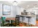 Eat-in kitchen with a breakfast bar, modern appliances, and updated countertops at 6681 121St Ave # I, Largo, FL 33773