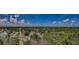 Expansive aerial shot of a community with tree-lined streets and scenic water views under a bright, partly cloudy sky at 7332 Janczlik Dr, New Port Richey, FL 34652
