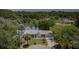 Aerial view of a charming waterfront home with a well-maintained lawn and circular driveway at 7332 Janczlik Dr, New Port Richey, FL 34652