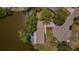 Aerial top-down view of a home backing to the river with lush surrounding landscape and mature trees at 7332 Janczlik Dr, New Port Richey, FL 34652