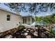 Inviting backyard with a screened-in patio and a wooden deck overlooking the water and beautiful surrounding trees at 7332 Janczlik Dr, New Port Richey, FL 34652