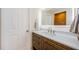 Well-lit bathroom featuring a wooden vanity with a white quartz countertop and modern fixtures at 7332 Janczlik Dr, New Port Richey, FL 34652