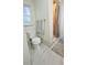Bathroom with a toilet, tiled floors, a shower with glass doors, and a window at 7332 Janczlik Dr, New Port Richey, FL 34652