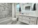 Modern bathroom features a marble tile backsplash, tiled floor, white vanity and updated fixtures at 7332 Janczlik Dr, New Port Richey, FL 34652