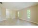 Well-lit bedroom features tile floors, neutral walls, ceiling fan and multiple windows at 7332 Janczlik Dr, New Port Richey, FL 34652