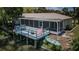 Waterfront home featuring a screened lanai, open deck, and a kayak, perfect for enjoying the water at 7332 Janczlik Dr, New Port Richey, FL 34652