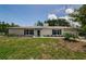 Charming single-story white brick home featuring blue shutters and a neatly kept lawn at 7332 Janczlik Dr, New Port Richey, FL 34652