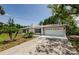 Charming single-story home with white brick, blue shutters, and a well-maintained front yard at 7332 Janczlik Dr, New Port Richey, FL 34652