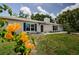 Charming, light brick house with blue shutters and landscaped yard, showcasing curb appeal and a welcoming entrance at 7332 Janczlik Dr, New Port Richey, FL 34652