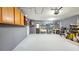 Spacious garage featuring ample storage, work area, utility sink and access door to the exterior at 7332 Janczlik Dr, New Port Richey, FL 34652