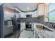 Charming kitchen with stainless steel appliances, granite countertops, and a decorative backsplash at 7332 Janczlik Dr, New Port Richey, FL 34652