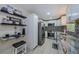 Well-lit kitchen features sleek stainless steel appliances, white cabinetry, and decorative tile backsplash at 7332 Janczlik Dr, New Port Richey, FL 34652