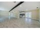Large living space featuring tile floors, neutral tones, and an open layout connecting to the kitchen at 7332 Janczlik Dr, New Port Richey, FL 34652