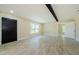 Spacious living room featuring tile floors, neutral walls, and a rustic beam at 7332 Janczlik Dr, New Port Richey, FL 34652