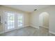 Neutral room with tile floors, arched doorway and French doors leading to the outdoors at 7332 Janczlik Dr, New Port Richey, FL 34652