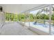 Screened in patio features durable tile flooring and access to a deck overlooking peaceful views of the lake at 7332 Janczlik Dr, New Port Richey, FL 34652