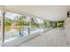 Enclosed patio overlooking the water with a deck and lush greenery at 7332 Janczlik Dr, New Port Richey, FL 34652