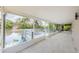 Spacious screened-in porch features tile floors, view of lake, and access to deck at 7332 Janczlik Dr, New Port Richey, FL 34652