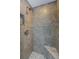 Tile shower with rainfall showerhead and bench seat features mosaic tile accent at 7332 Janczlik Dr, New Port Richey, FL 34652