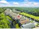 Features an aerial view of the home and neighborhood near a golf course at 7606 Berna Ln, Land O Lakes, FL 34637