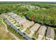 Features an aerial view of the home backing up to a wooded lot at 7606 Berna Ln, Land O Lakes, FL 34637