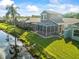 Backyard featuring a water view and screened lanai with patio at 7606 Berna Ln, Land O Lakes, FL 34637