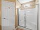 Clean bathroom featuring a glass-enclosed shower and neutral finishes at 7606 Berna Ln, Land O Lakes, FL 34637
